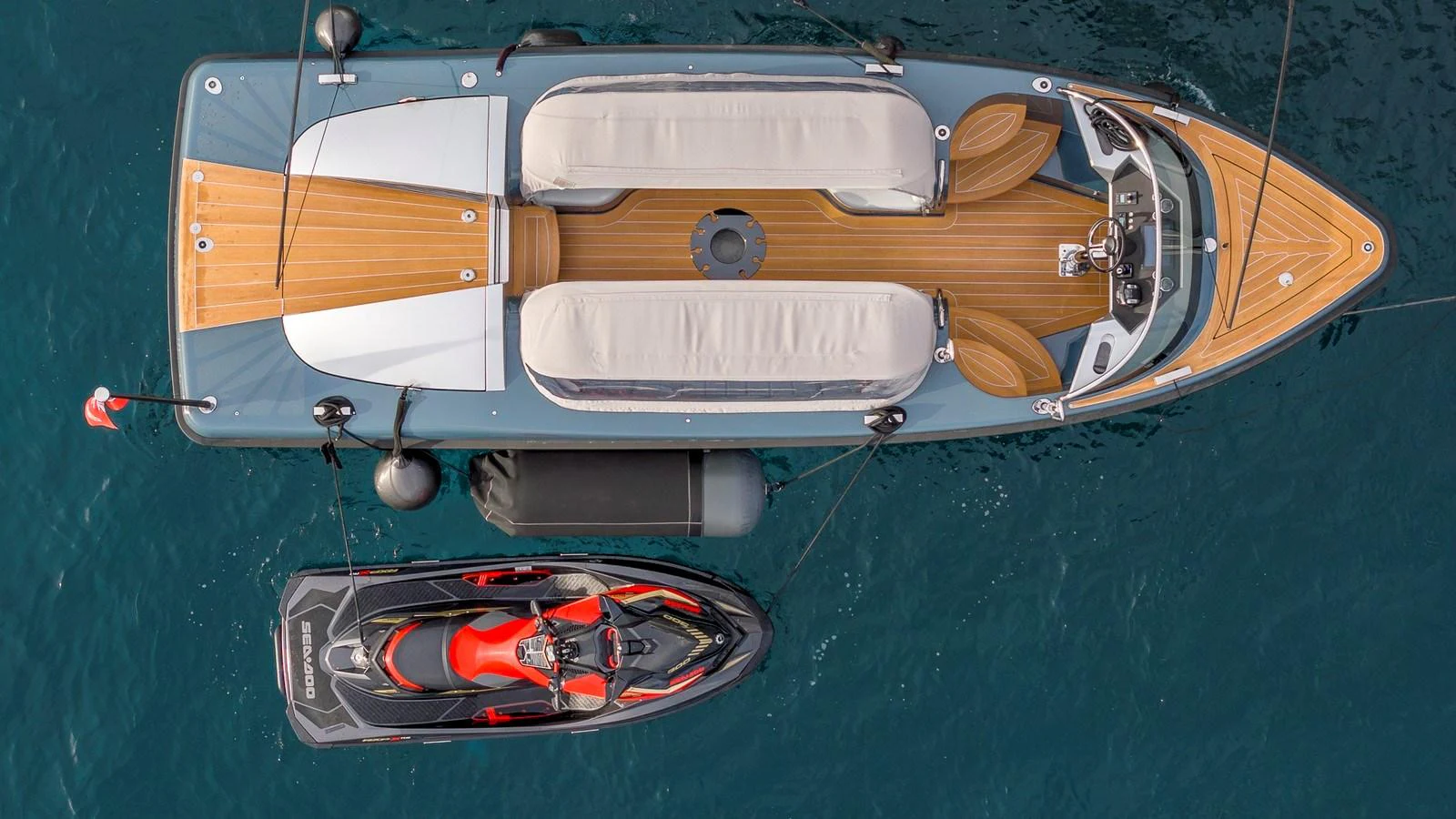 A sleek tender yacht with a jet ski alongside, viewed from above. aboard NENINKA Yacht for Sale