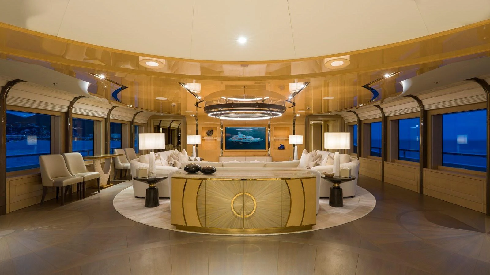 The yacht's salon features luxurious seating and elegant lighting with panoramic views. aboard NENINKA Yacht for Sale