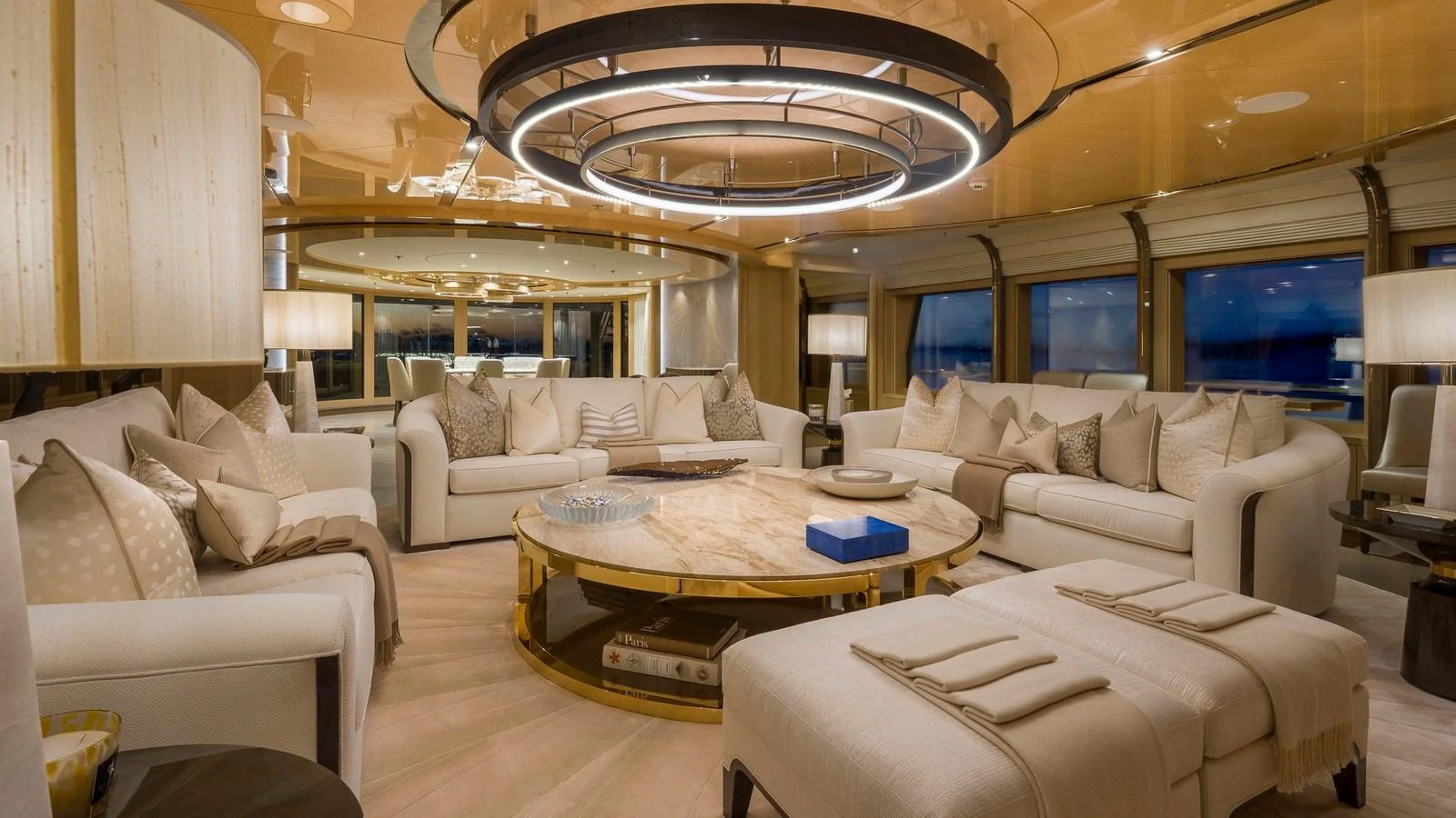 The salon features luxurious seating and elegant lighting, creating a warm and inviting atmosphere. aboard NENINKA Yacht for Sale