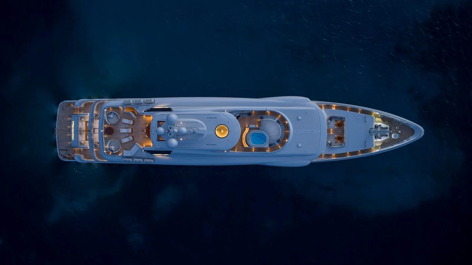 A stunning aerial view of a luxury yacht illuminated at night. aboard NENINKA Yacht for Sale