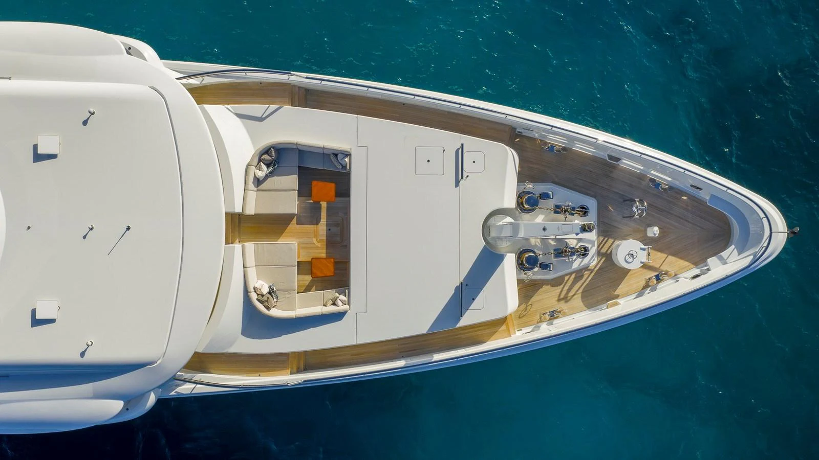 Aerial view of the yacht's bow showcasing a spacious lounging area with seating and tables. aboard NENINKA Yacht for Sale