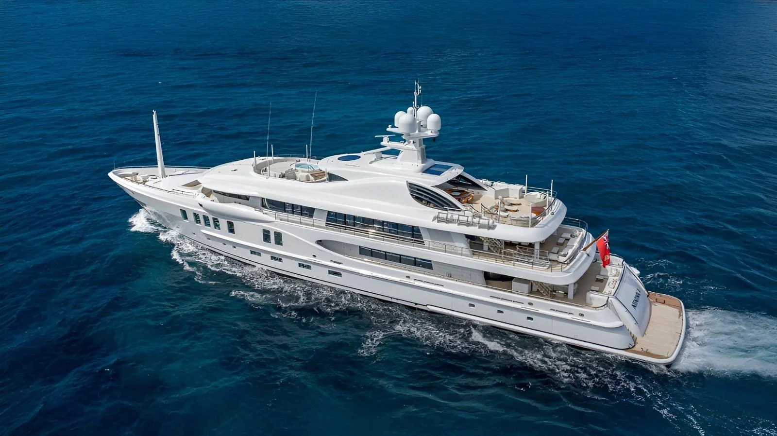 A luxurious yacht cruises through the deep blue sea, showcasing its elegant design and spacious decks. aboard NENINKA Yacht for Sale