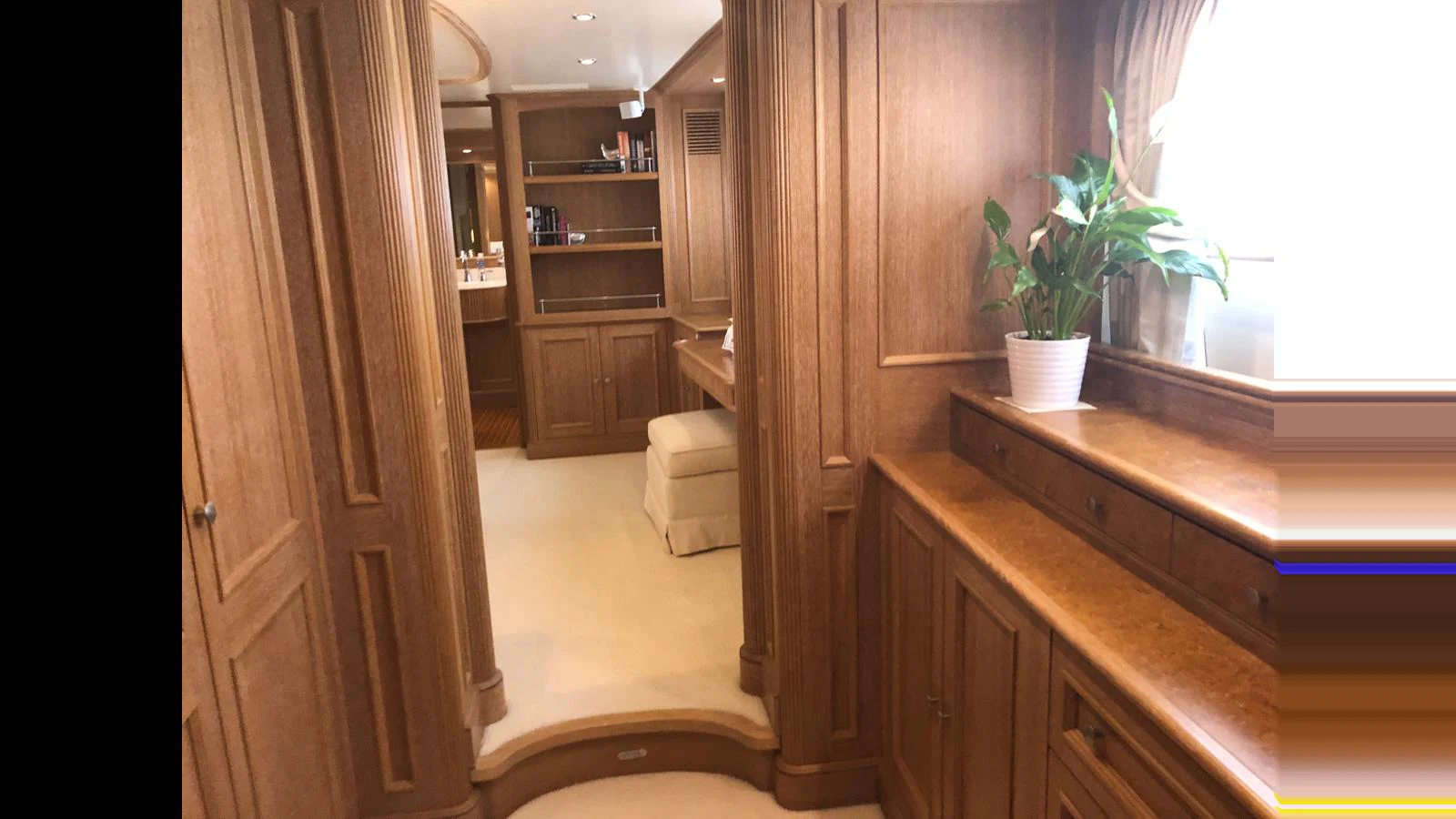 The yacht's interior features elegant wooden cabinetry and a cozy seating area. aboard ALBATROSS Yacht for Sale