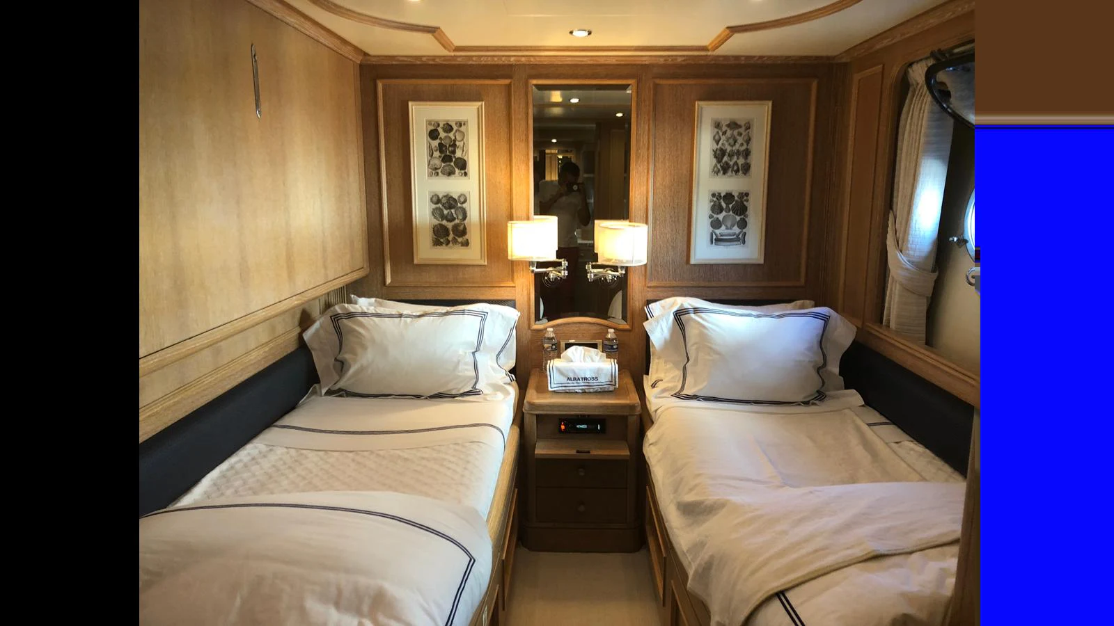 The twin stateroom features two comfortable beds with elegant bedding and warm wooden accents. aboard ALBATROSS Yacht for Sale