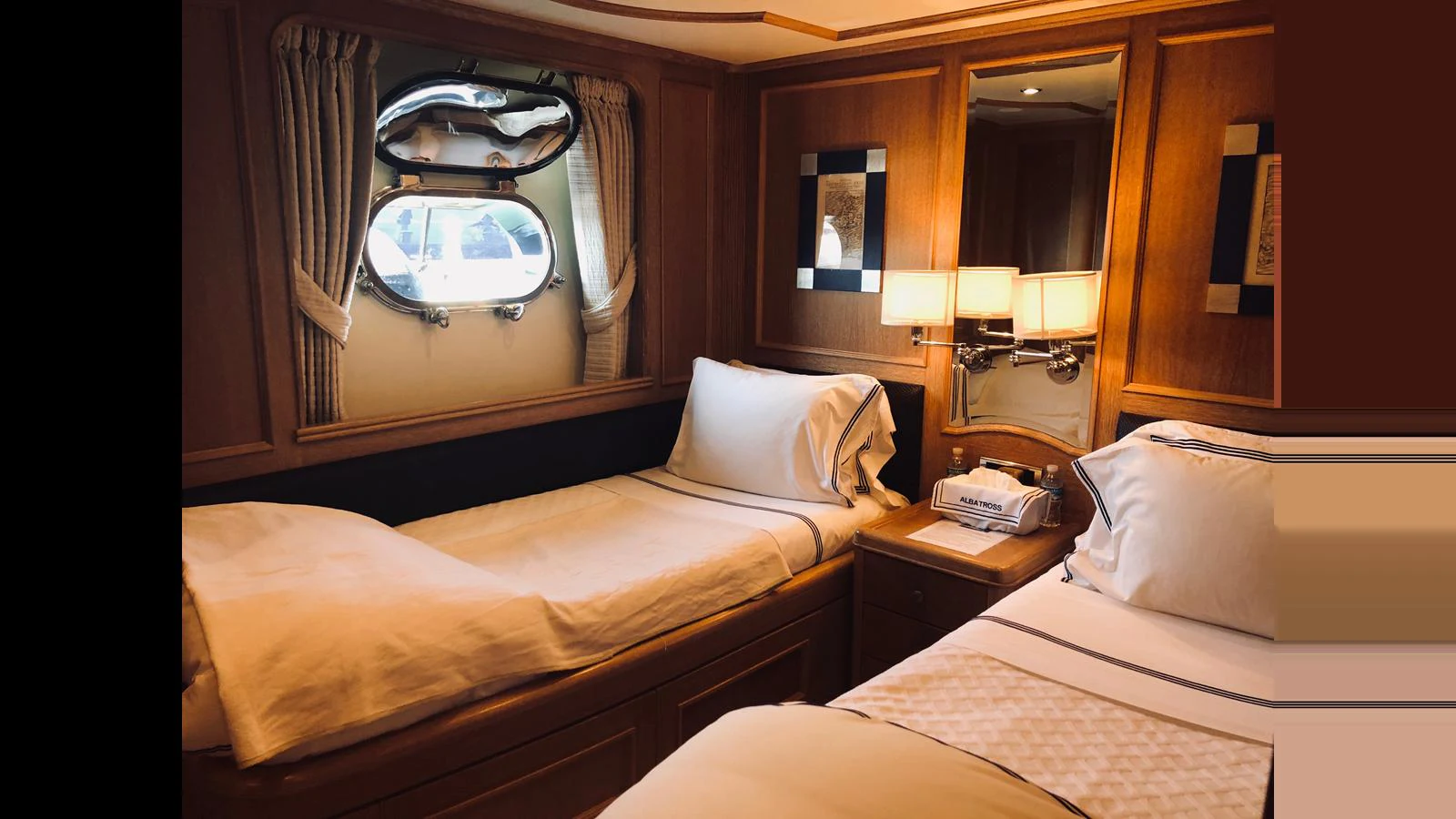 The guest stateroom features twin beds and elegant wooden paneling. aboard ALBATROSS Yacht for Sale