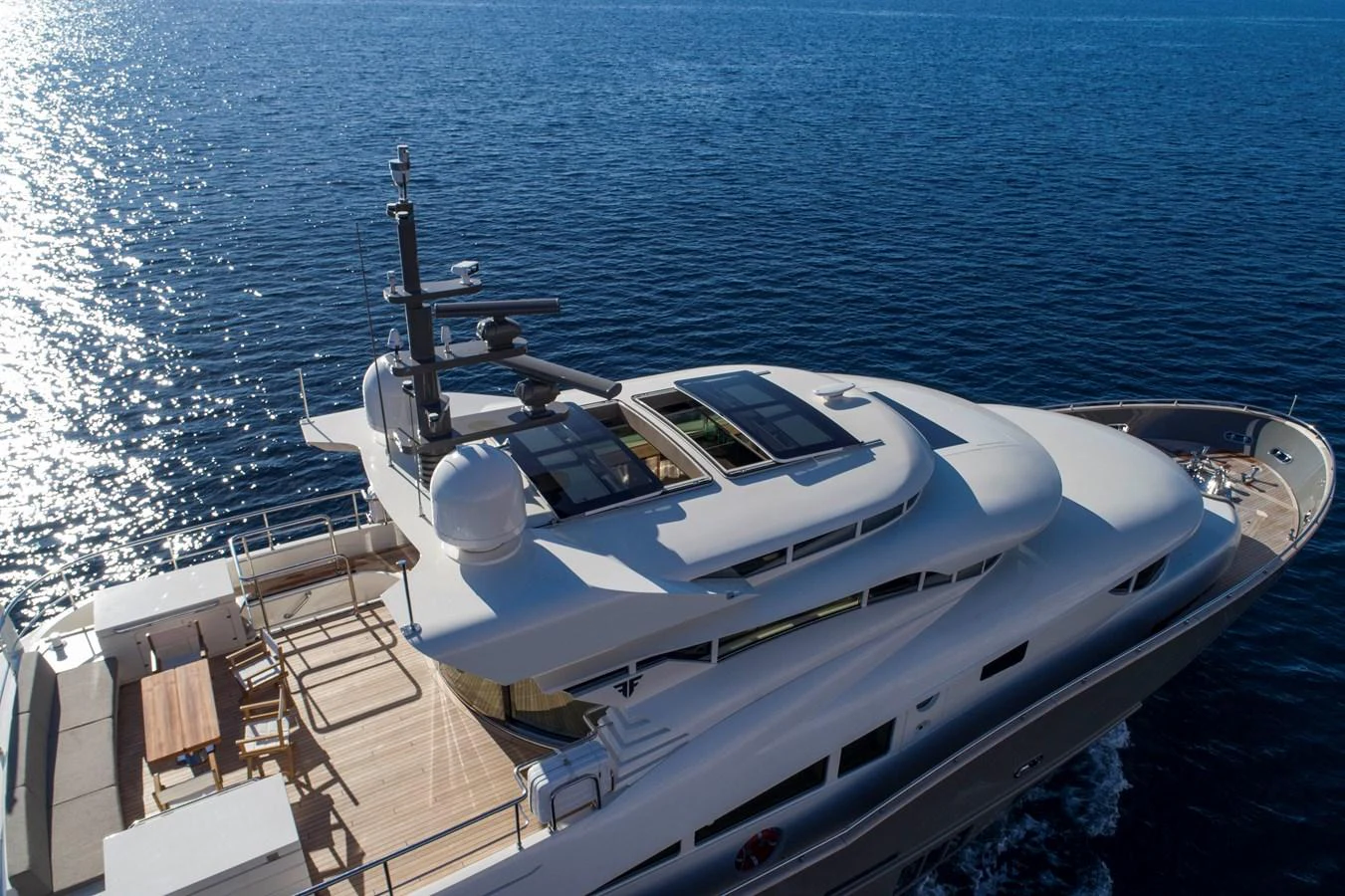 This sleek yacht glides gracefully on the water, showcasing its modern flybridge and spacious deck. aboard MAXIMA Yacht for Sale