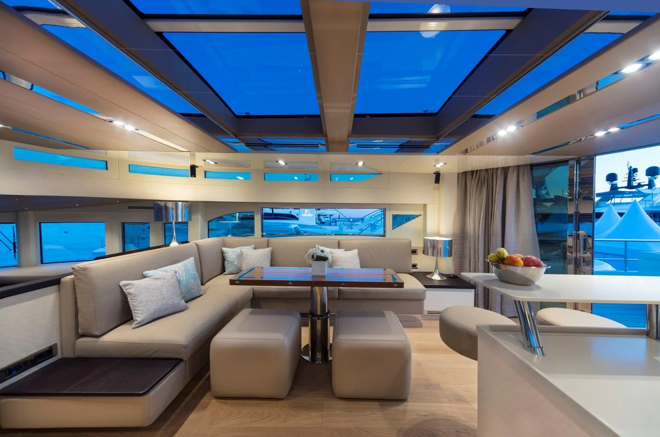 The salon features a spacious seating area with large windows and a modern design. aboard MAXIMA Yacht for Sale