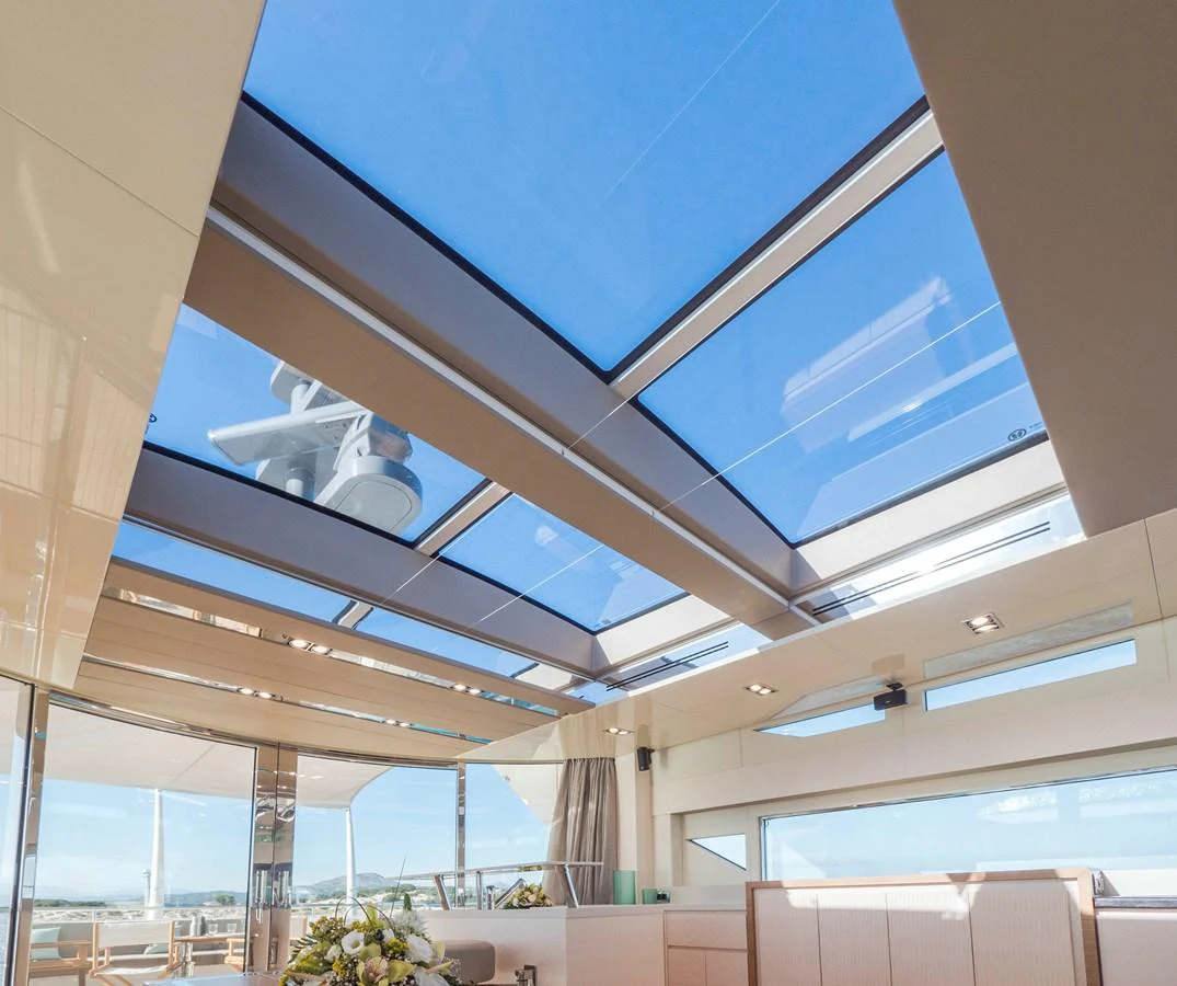 The yacht's interior features a stunning skylight ceiling, allowing natural light to flood the space. aboard MAXIMA Yacht for Sale