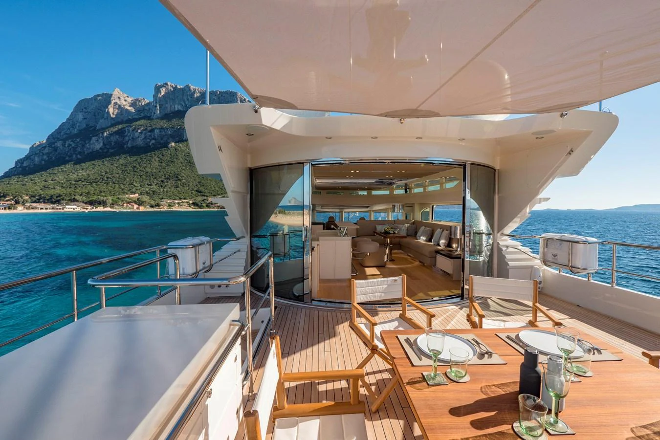 The aft deck offers a luxurious outdoor dining area with stunning views of the surrounding waters and coastline. aboard MAXIMA Yacht for Sale