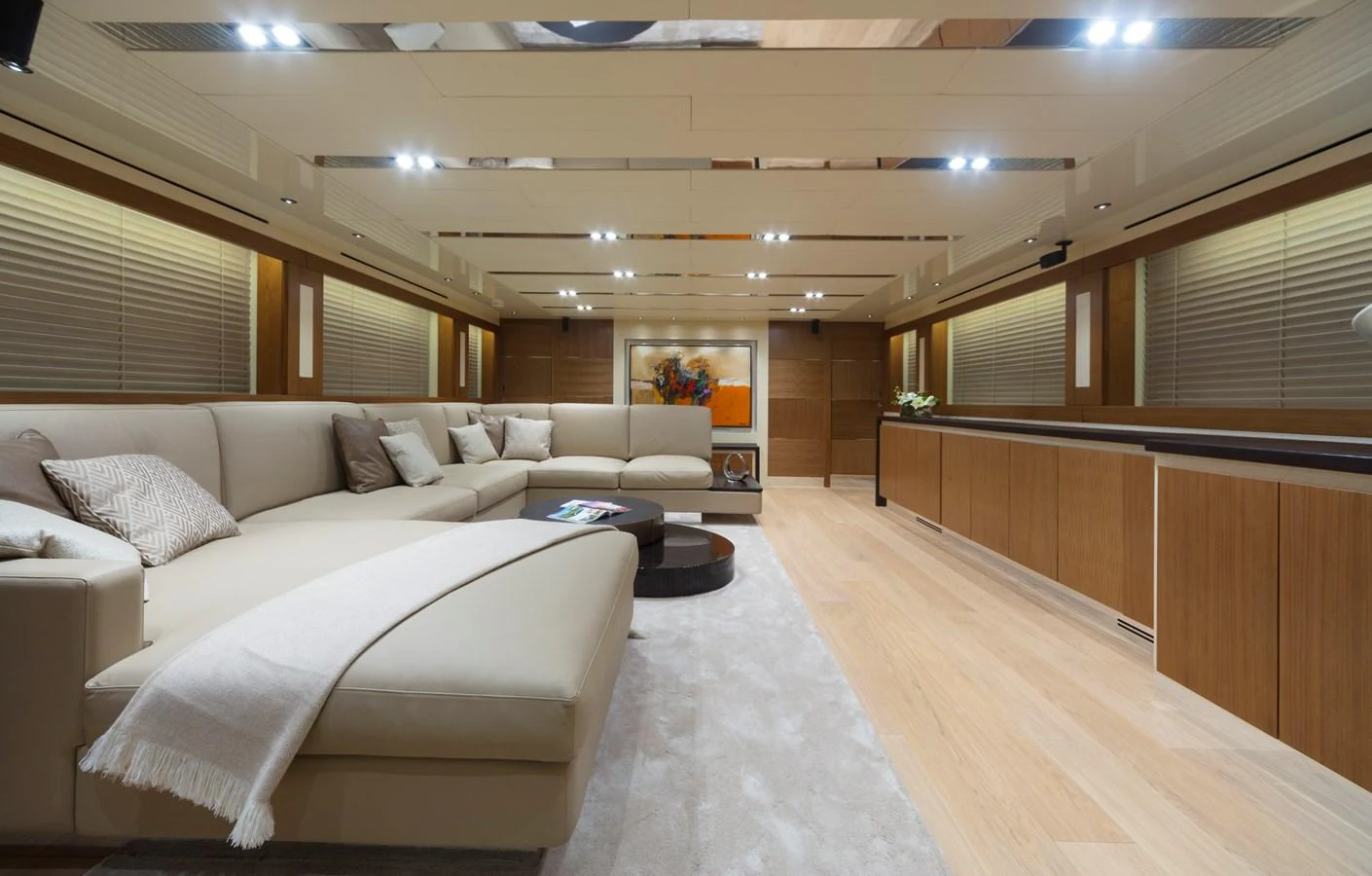 The salon features a spacious and elegant seating area with modern decor and ample lighting. aboard MAXIMA Yacht for Sale