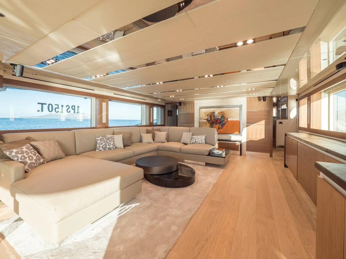 The salon features a spacious and elegant seating area with ample natural light and modern decor. aboard MAXIMA Yacht for Sale