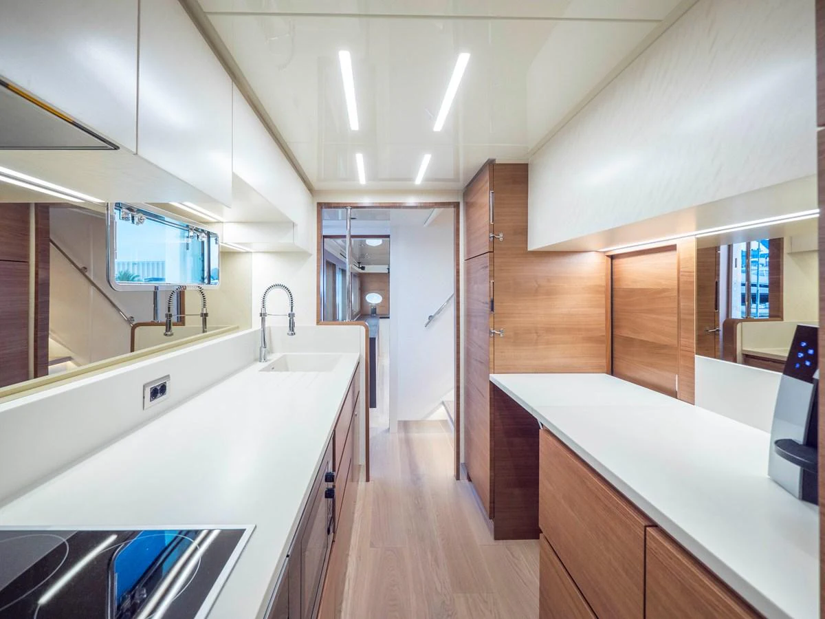 The yacht's galley features modern appliances and sleek cabinetry, creating a functional and stylish cooking space. aboard MAXIMA Yacht for Sale
