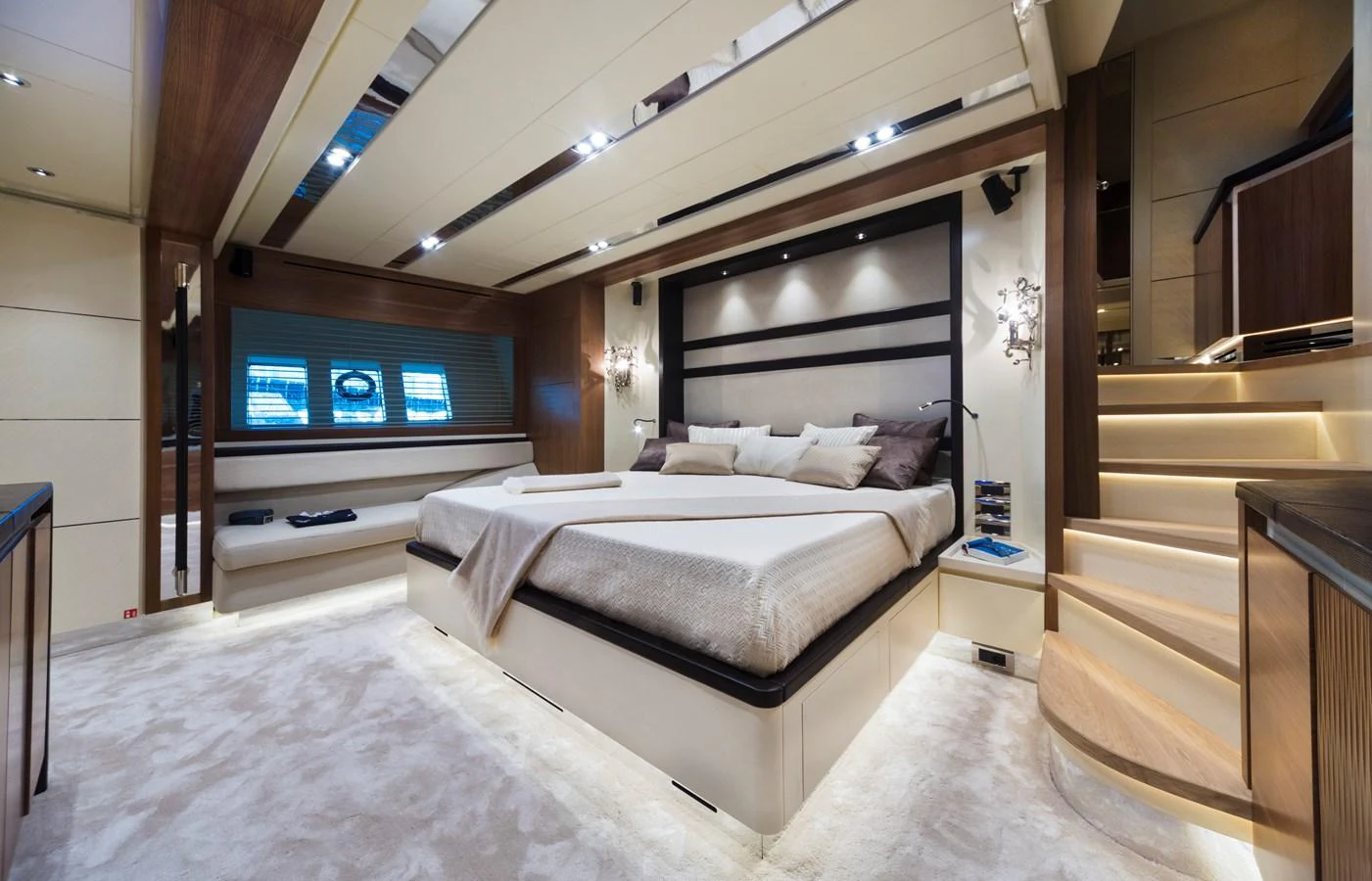 The master stateroom features a luxurious bed with elegant lighting and modern decor. aboard MAXIMA Yacht for Sale
