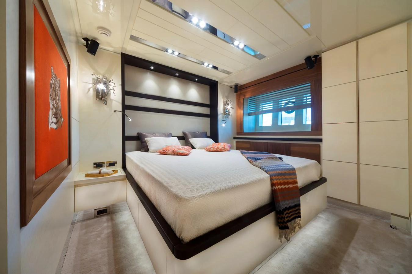 The master stateroom features a luxurious bed with elegant lighting and modern decor. aboard MAXIMA Yacht for Sale
