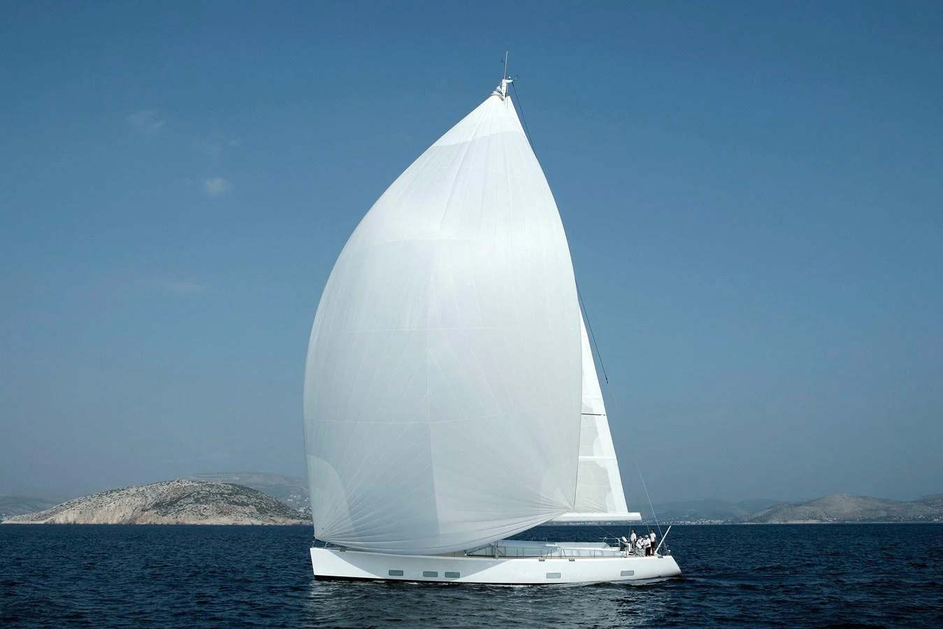 A sleek sailing yacht glides gracefully on the open water under a full sail. aboard S/Y SENTINEL Yacht for Sale