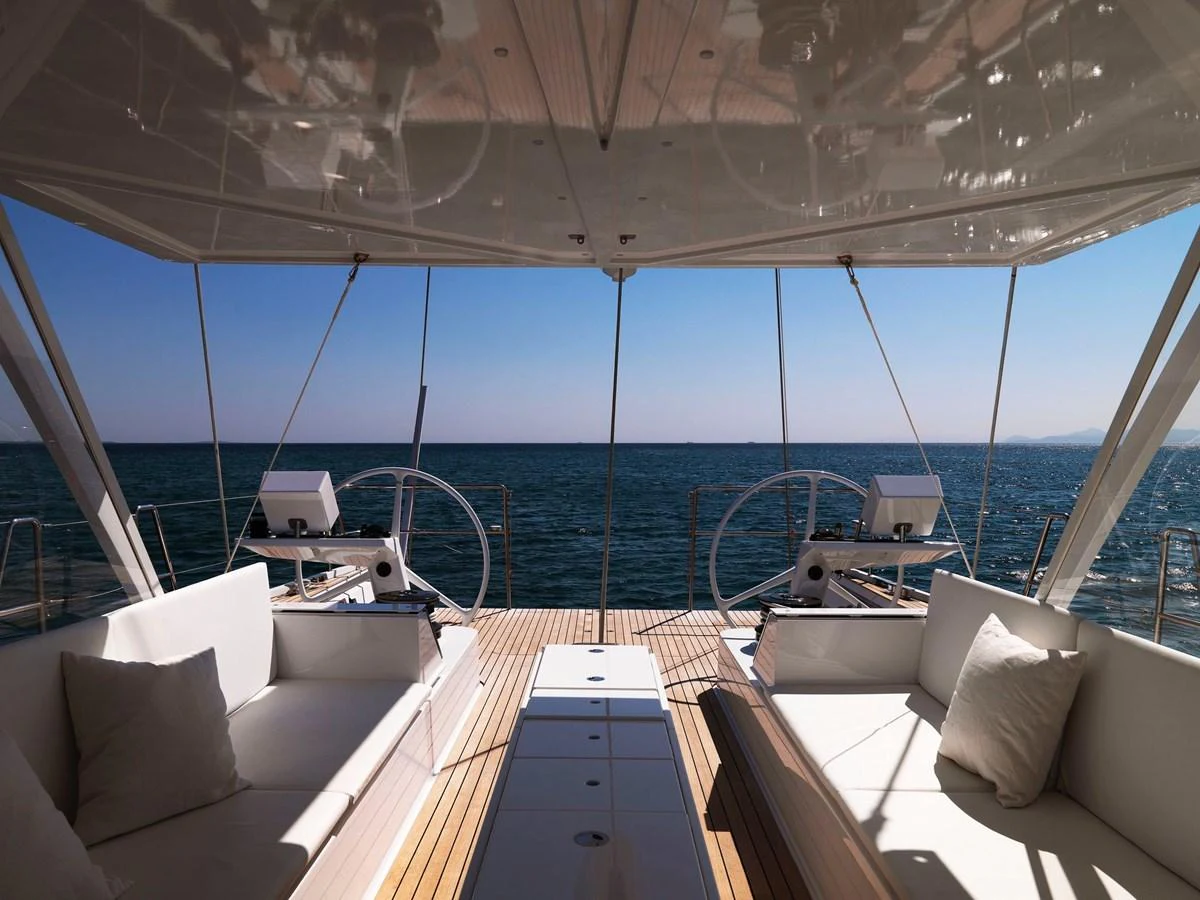 The aft deck offers a serene view of the sea with comfortable seating and modern helm stations. aboard S/Y SENTINEL Yacht for Sale