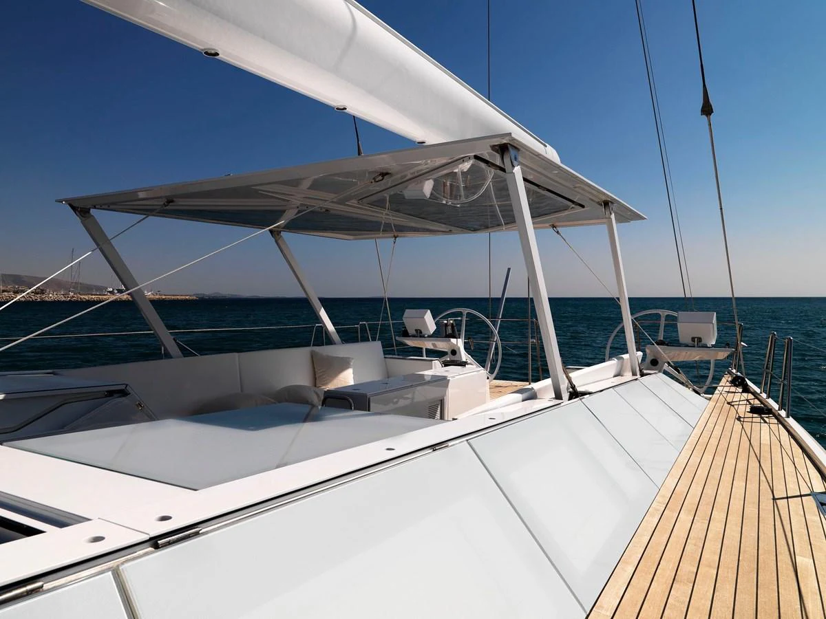 The yacht's deck offers a sleek and modern design with ample seating and shade. aboard S/Y SENTINEL Yacht for Sale