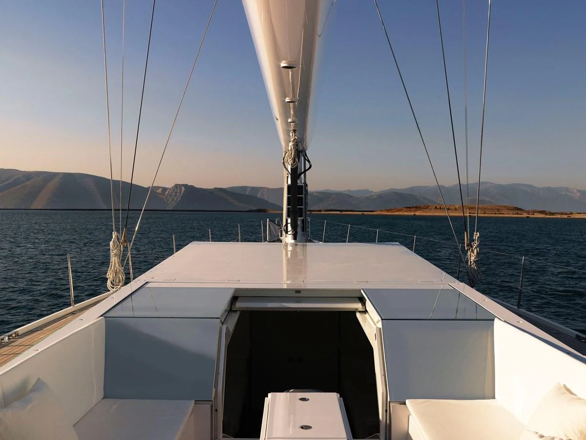 The yacht's deck offers a spacious and serene view of the surrounding waters and distant hills. aboard S/Y SENTINEL Yacht for Sale