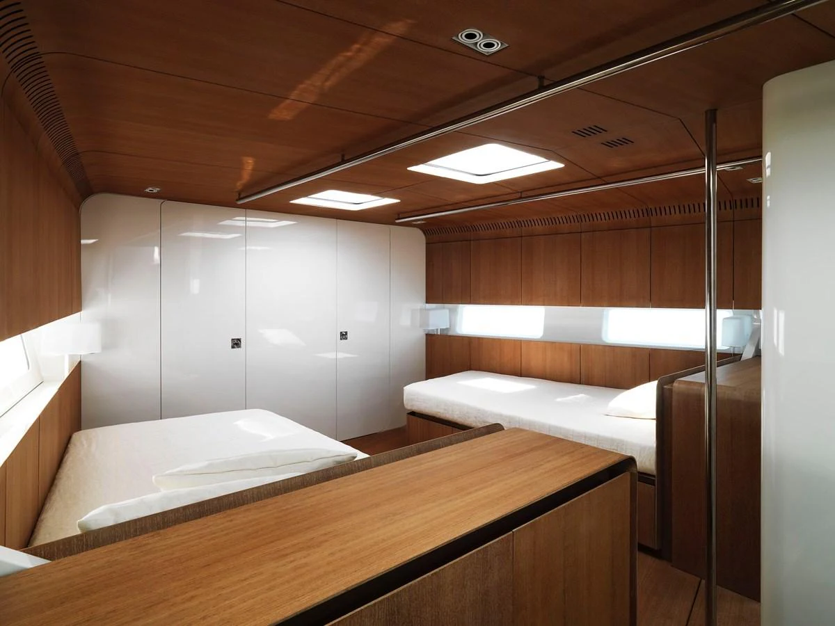 The stateroom features sleek wooden finishes and ample natural light. aboard S/Y SENTINEL Yacht for Sale