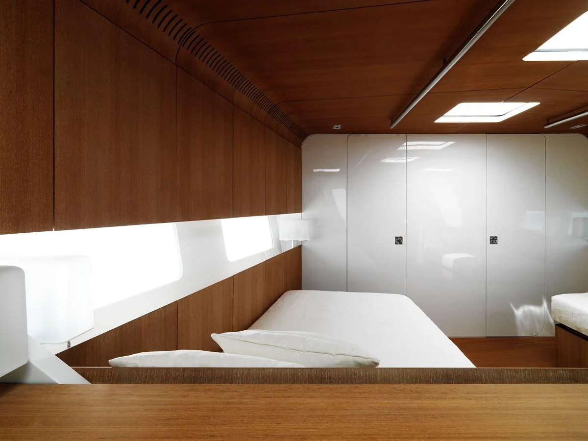 The stateroom features sleek wooden paneling and modern lighting, creating a cozy and elegant atmosphere. aboard S/Y SENTINEL Yacht for Sale