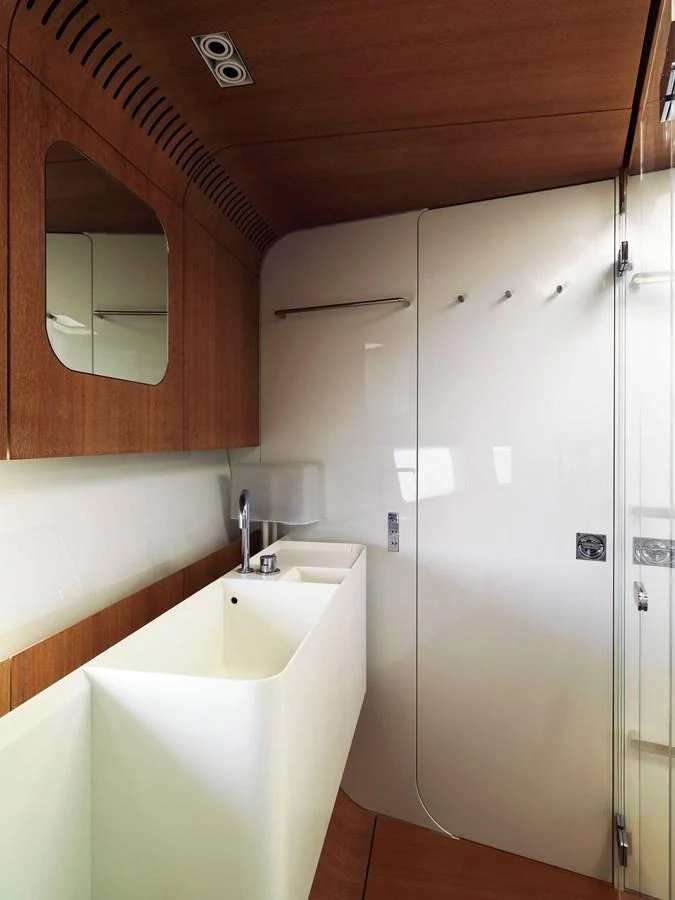 The yacht's bathroom features modern fixtures and elegant wooden accents. aboard S/Y SENTINEL Yacht for Sale