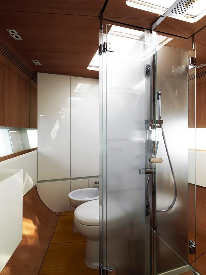 The yacht's bathroom features a modern glass shower and sleek fixtures. aboard S/Y SENTINEL Yacht for Sale
