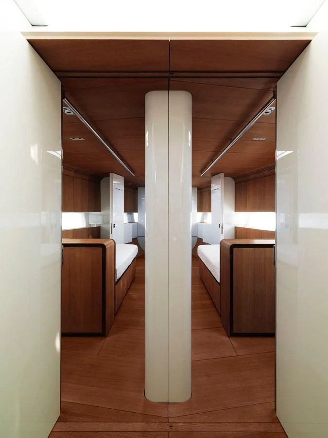 The image showcases a modern stateroom with sleek wooden finishes and twin beds. aboard S/Y SENTINEL Yacht for Sale