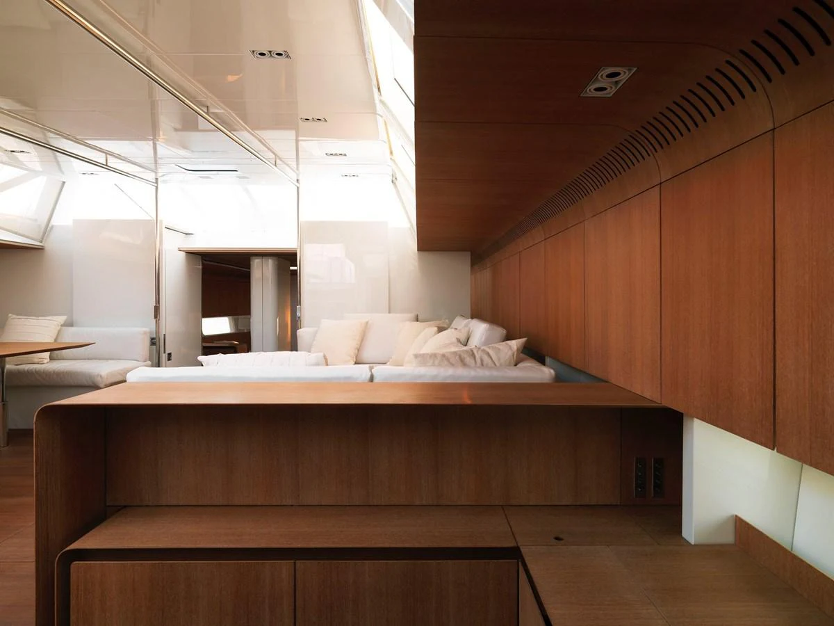 The yacht's interior features a modern, wood-accented design with comfortable seating and ample natural light. aboard S/Y SENTINEL Yacht for Sale