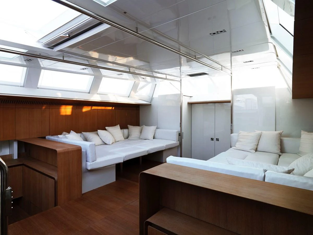 The yacht's interior features a spacious and modern seating area with ample natural light. aboard S/Y SENTINEL Yacht for Sale
