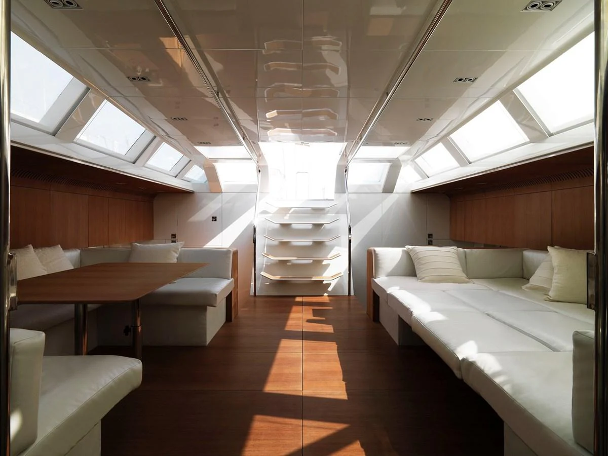 The yacht's interior features a spacious and well-lit seating area with modern furnishings. aboard S/Y SENTINEL Yacht for Sale