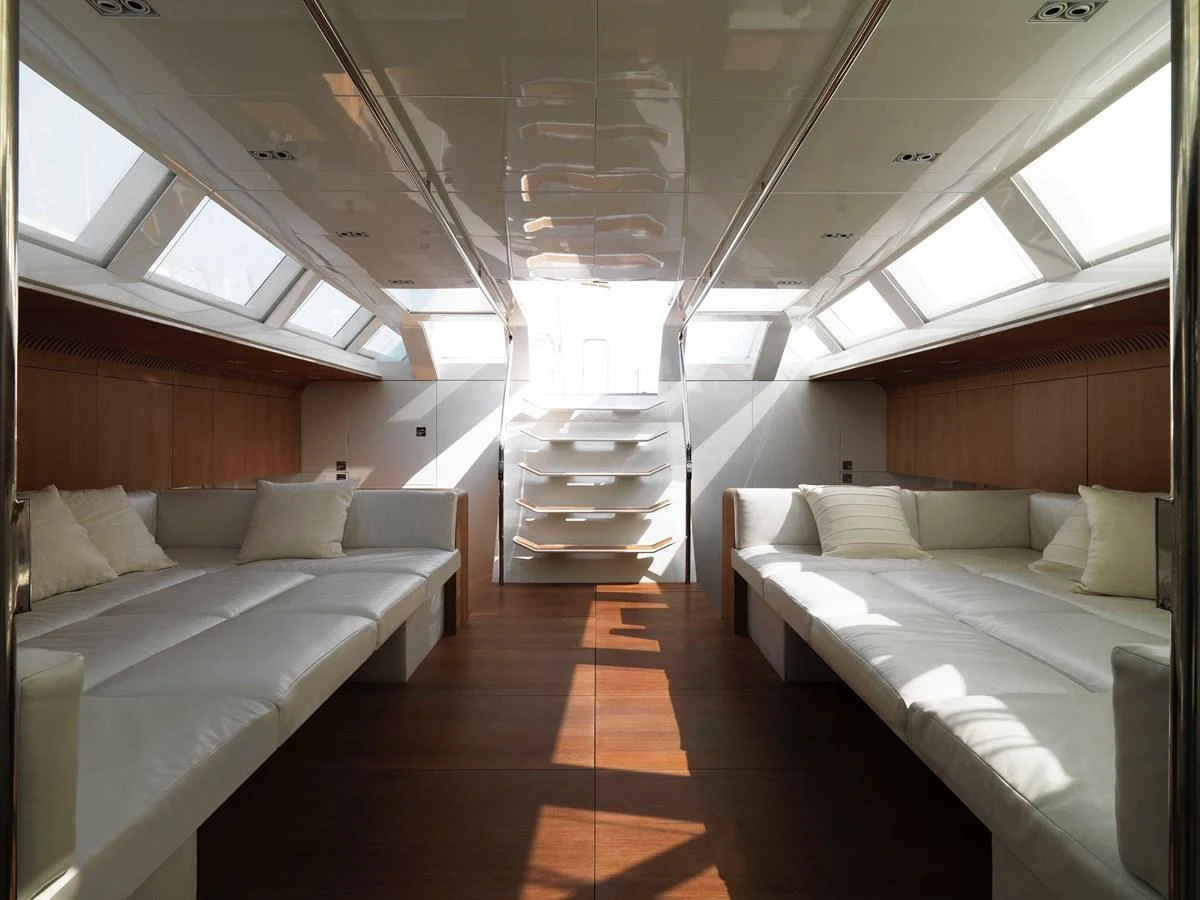The yacht's interior features a spacious and well-lit lounge area with comfortable seating. aboard S/Y SENTINEL Yacht for Sale