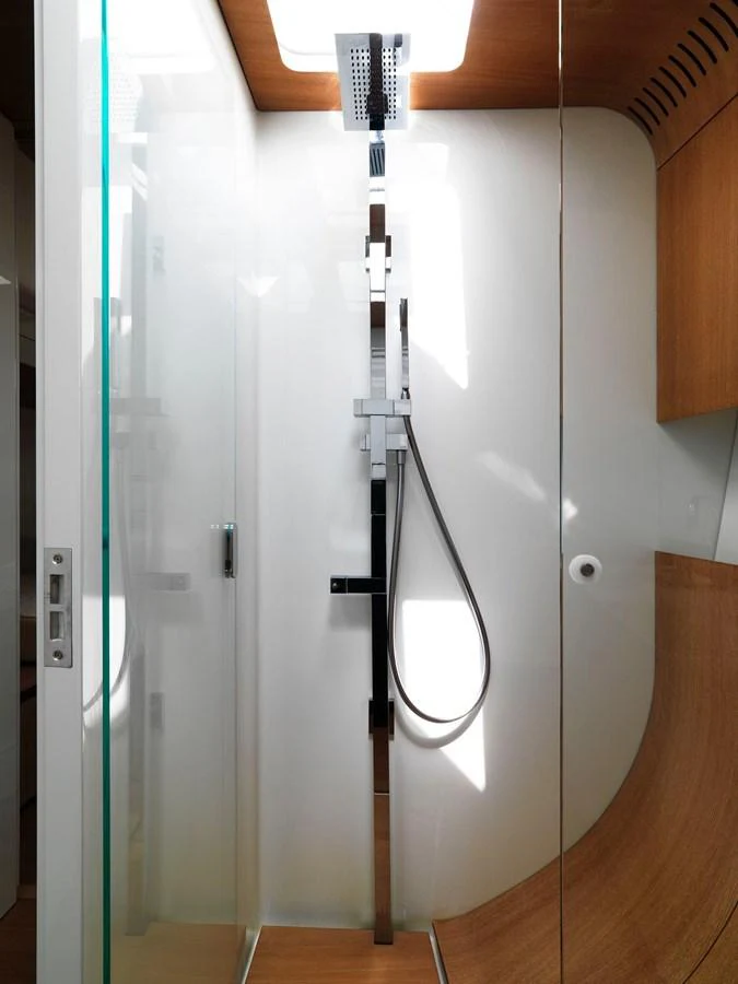 A sleek and modern shower area with wood accents and glass enclosure. aboard S/Y SENTINEL Yacht for Sale
