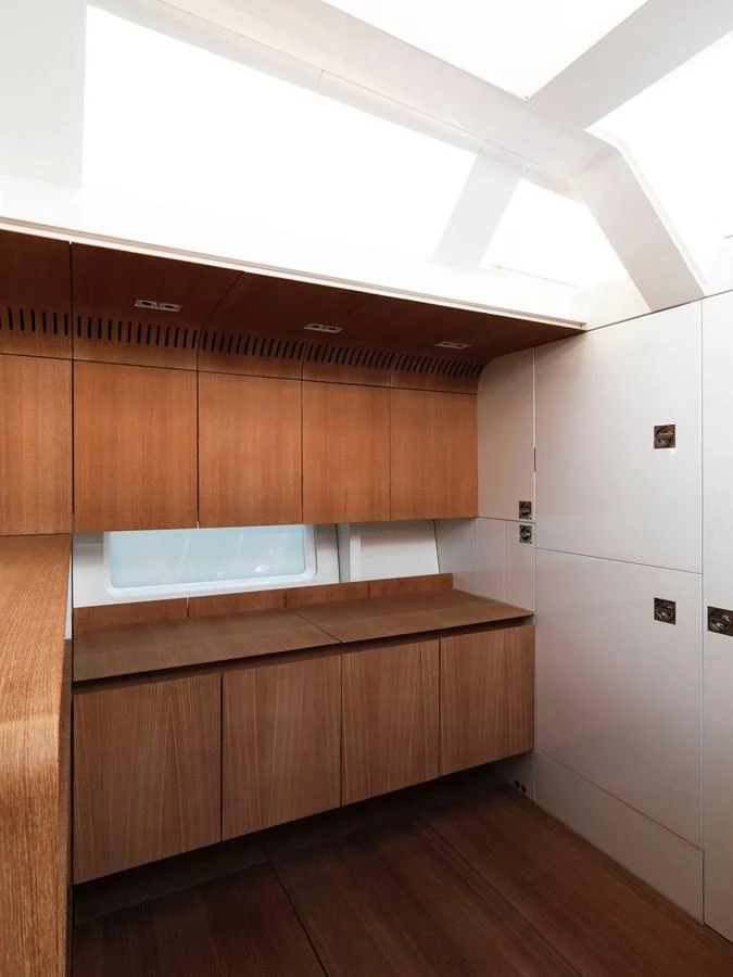 The yacht's galley features sleek wooden cabinetry and modern design elements. aboard S/Y SENTINEL Yacht for Sale