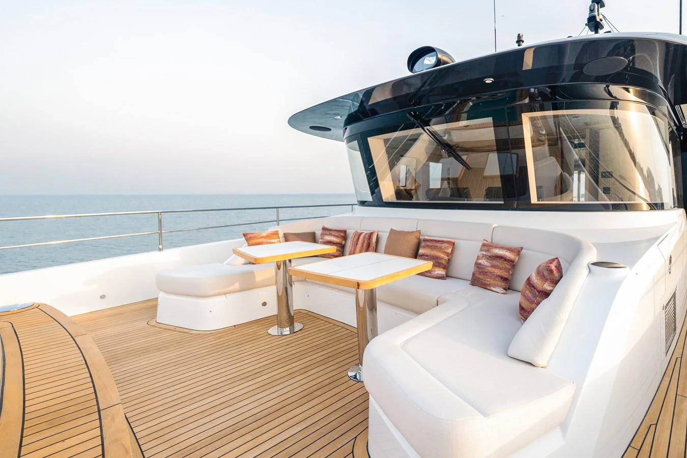 The aft deck offers a luxurious seating area with plush cushions and elegant tables, perfect for relaxation and socializing. aboard MAJESTY 100 TERRACE Yacht for Sale