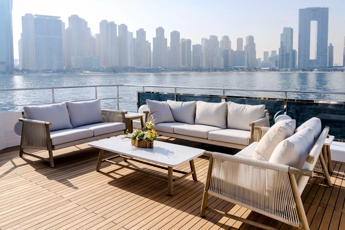 The aft deck features a stylish outdoor seating area with a stunning city skyline view. aboard MAJESTY 100 TERRACE Yacht for Sale
