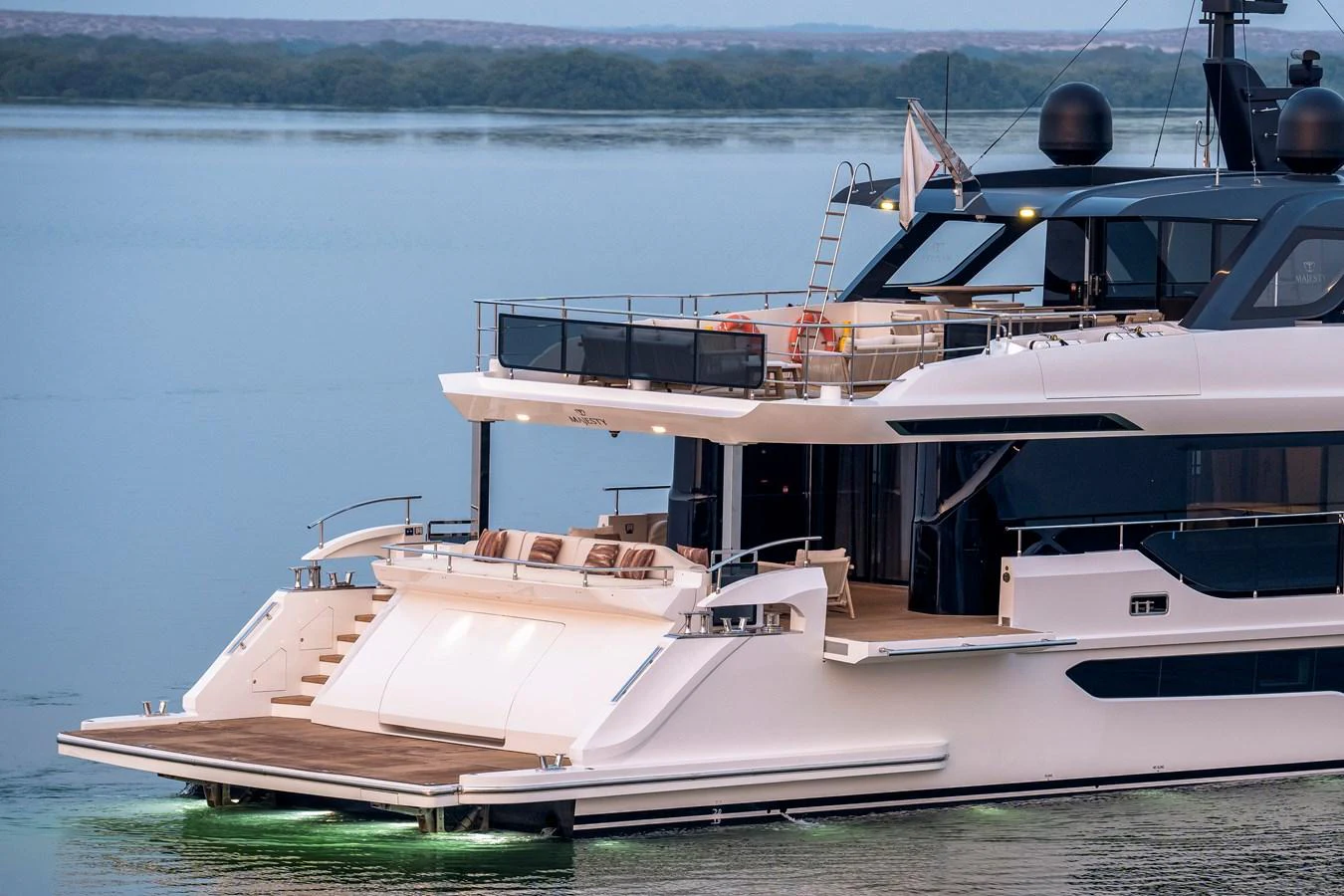 The yacht's aft deck features a spacious lounging area with elegant design and ambient lighting. aboard MAJESTY 100 TERRACE Yacht for Sale