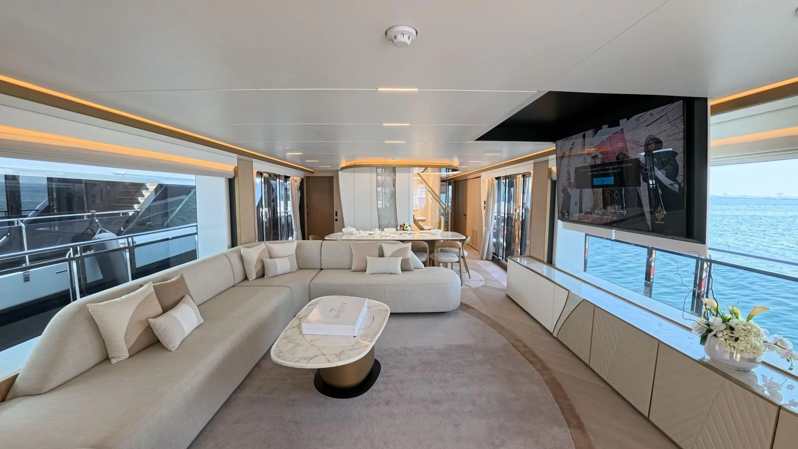 The spacious salon features elegant seating, a modern entertainment system, and panoramic windows offering stunning sea views. aboard MAJESTY 100 TERRACE Yacht for Sale
