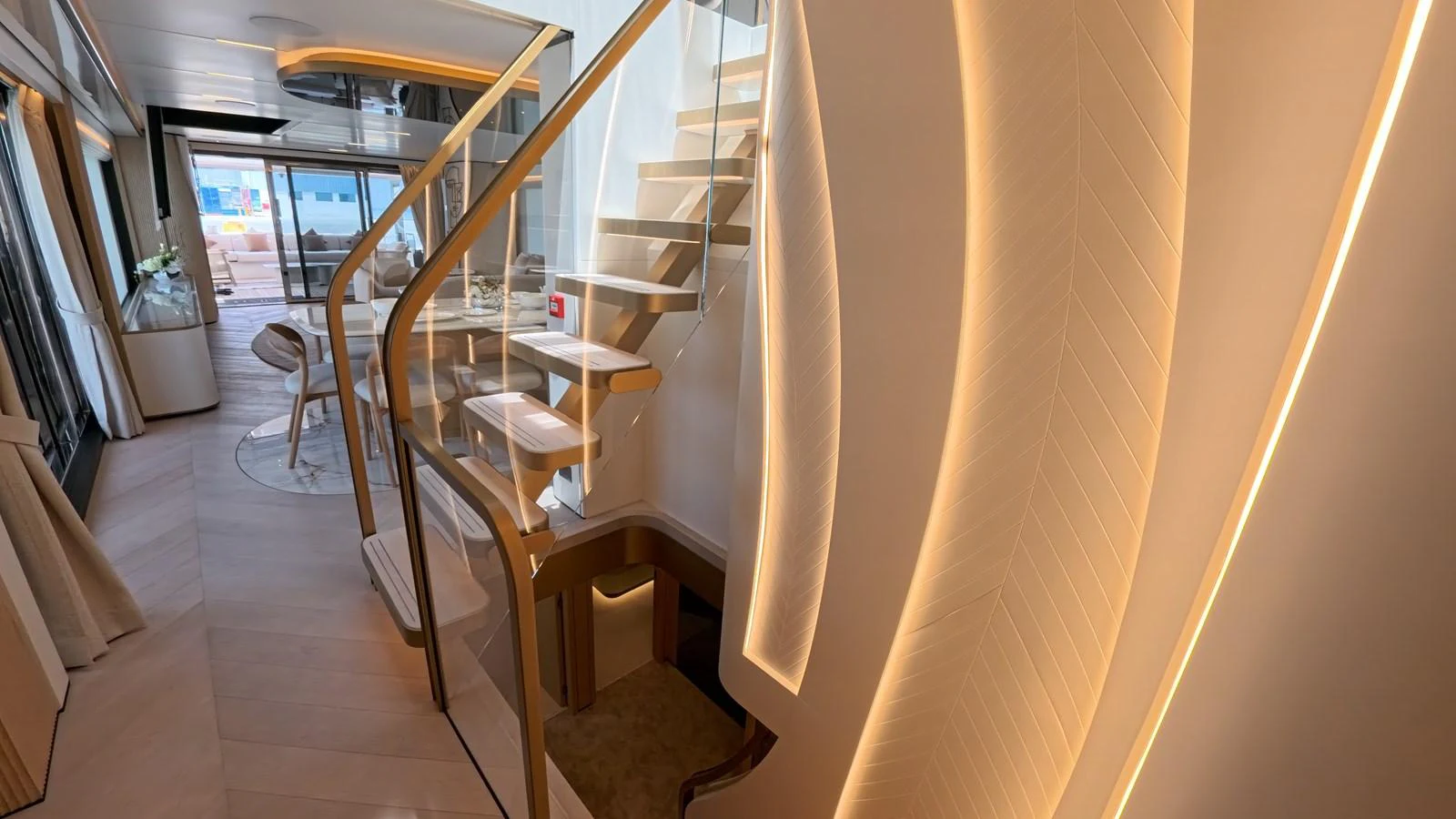 The yacht's interior features a modern staircase with elegant lighting and sleek design elements. aboard MAJESTY 100 TERRACE Yacht for Sale