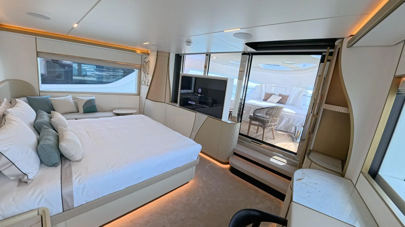 The master stateroom features a luxurious bed with elegant decor and a view of the outdoor seating area. aboard MAJESTY 100 TERRACE Yacht for Sale