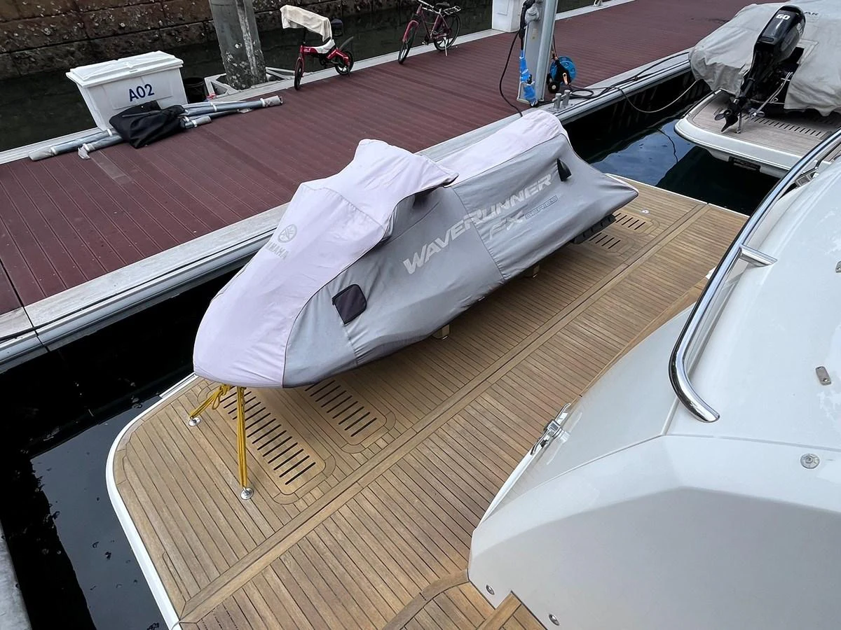 A covered jet ski is secured on the yacht's deck, ready for adventure. aboard PRINCESS CHLOE Yacht for Sale