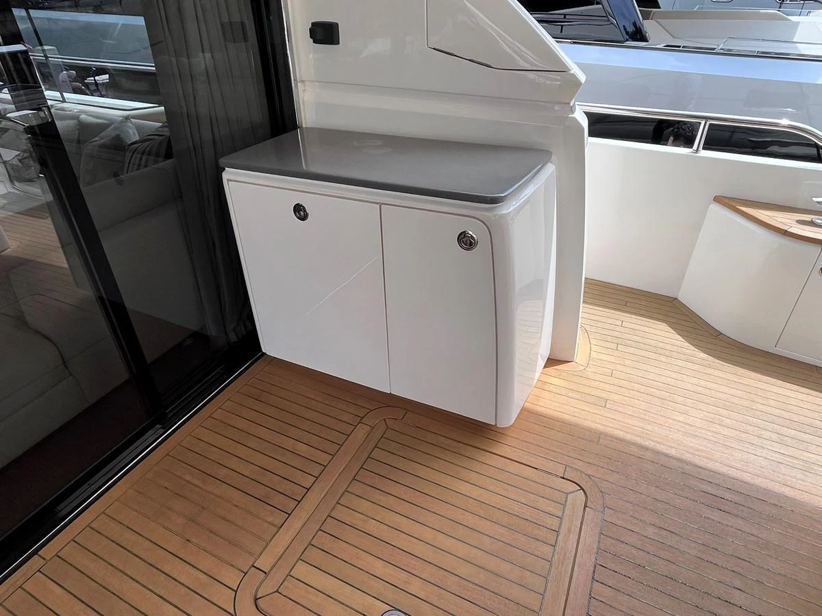 The image showcases a sleek storage cabinet on the deck of a yacht, with a clean and modern design. aboard PRINCESS CHLOE Yacht for Sale