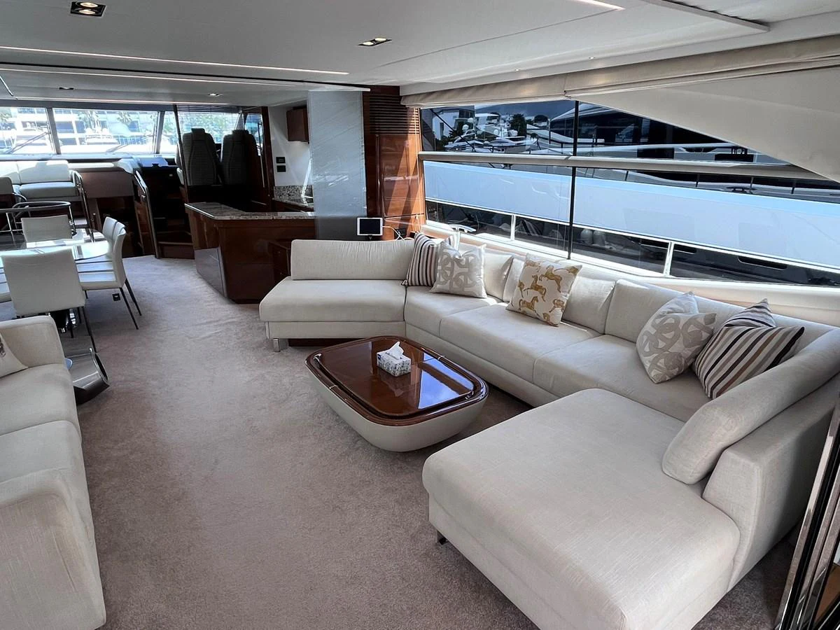 The spacious salon features a luxurious seating area with plush sofas and elegant decor. aboard PRINCESS CHLOE Yacht for Sale