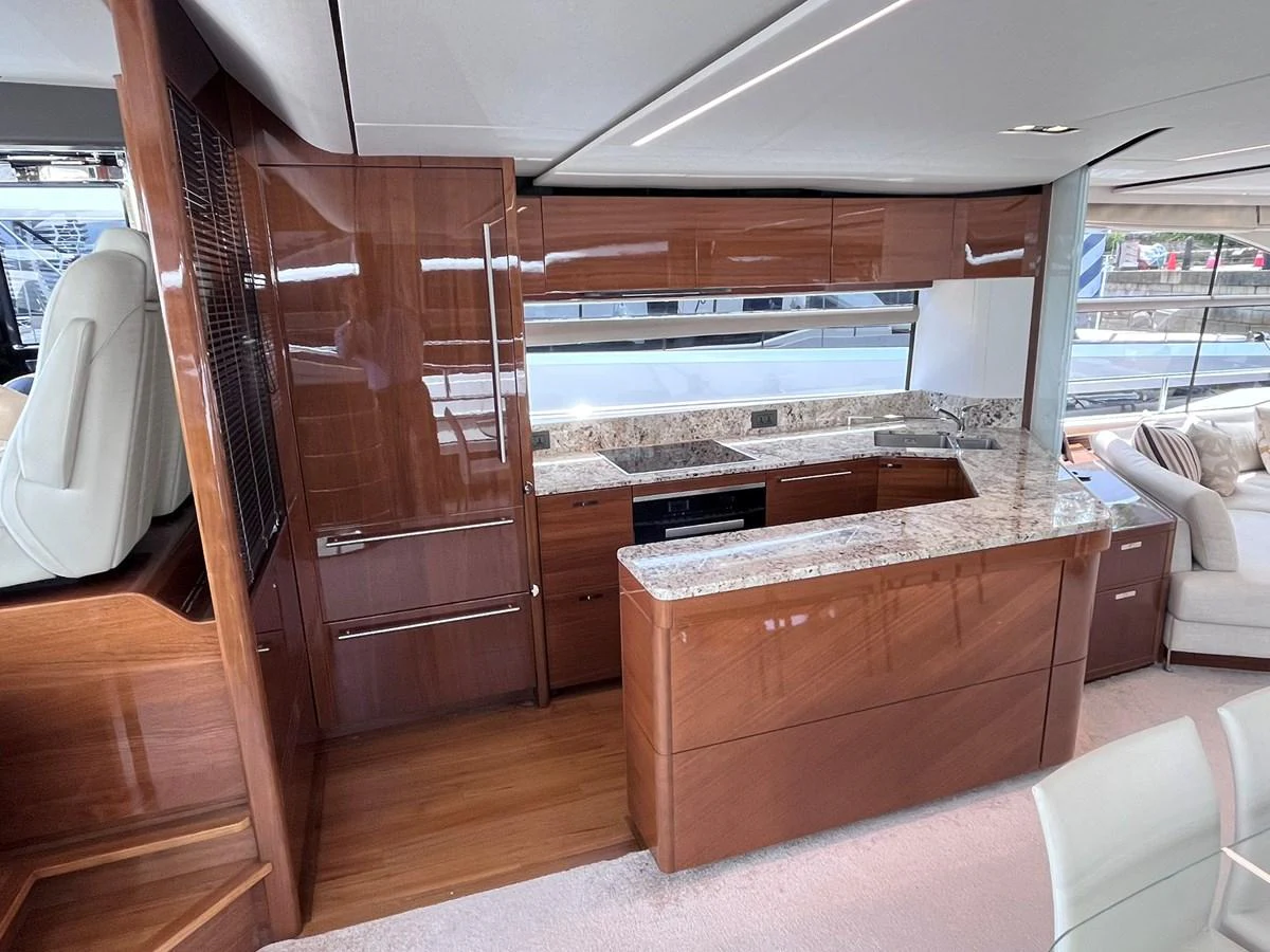 The galley features sleek wooden cabinetry and modern appliances, creating a warm and inviting space for culinary activities. aboard PRINCESS CHLOE Yacht for Sale