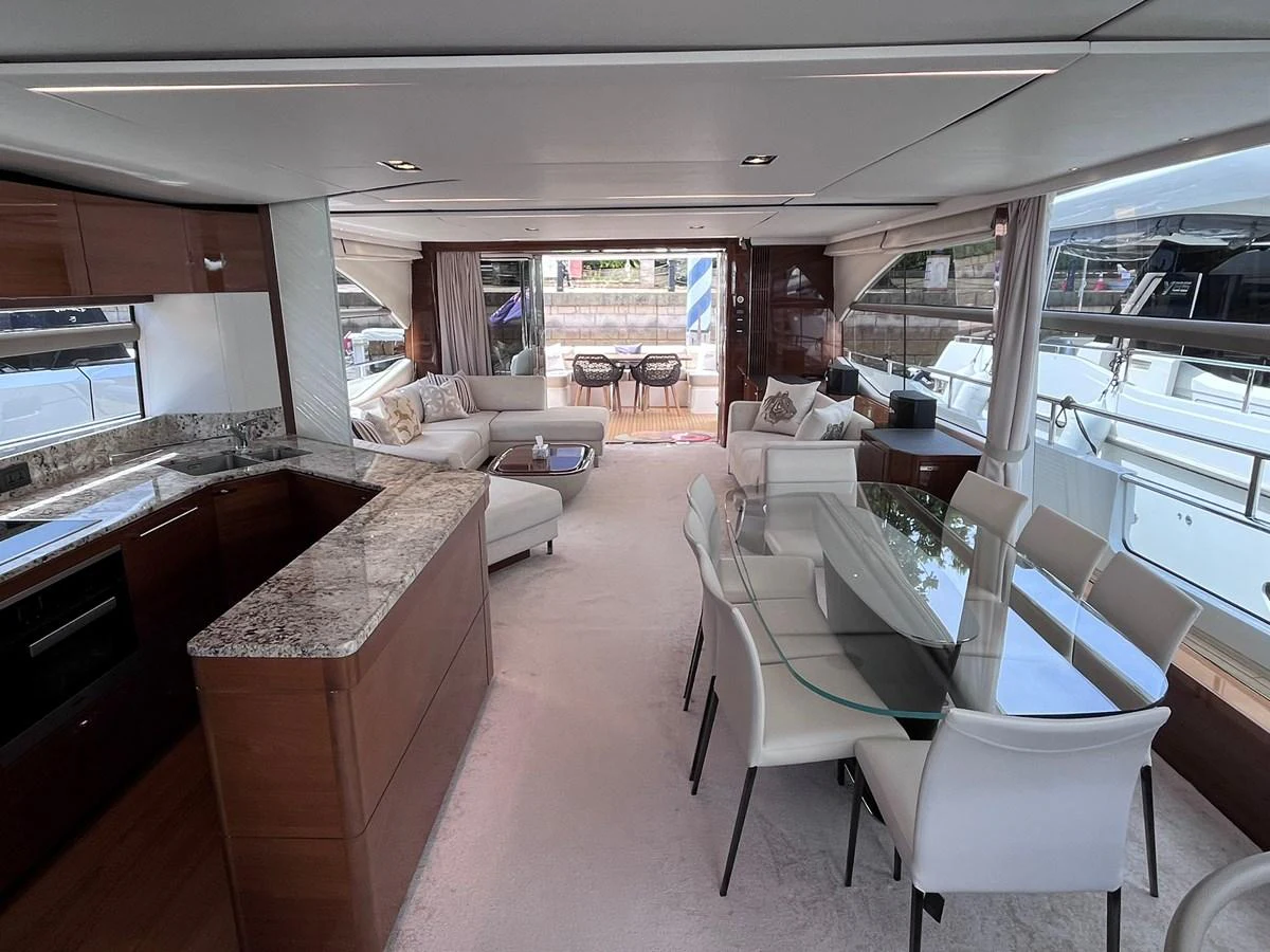The salon features a spacious and elegant layout with a dining area and comfortable seating. aboard PRINCESS CHLOE Yacht for Sale