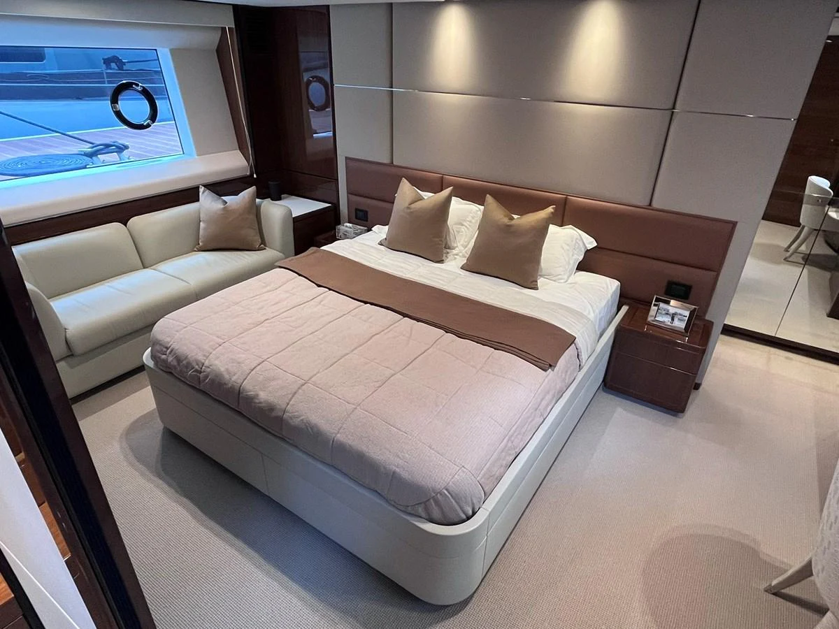 The master stateroom features a plush bed, a cozy sofa, and elegant decor. aboard PRINCESS CHLOE Yacht for Sale