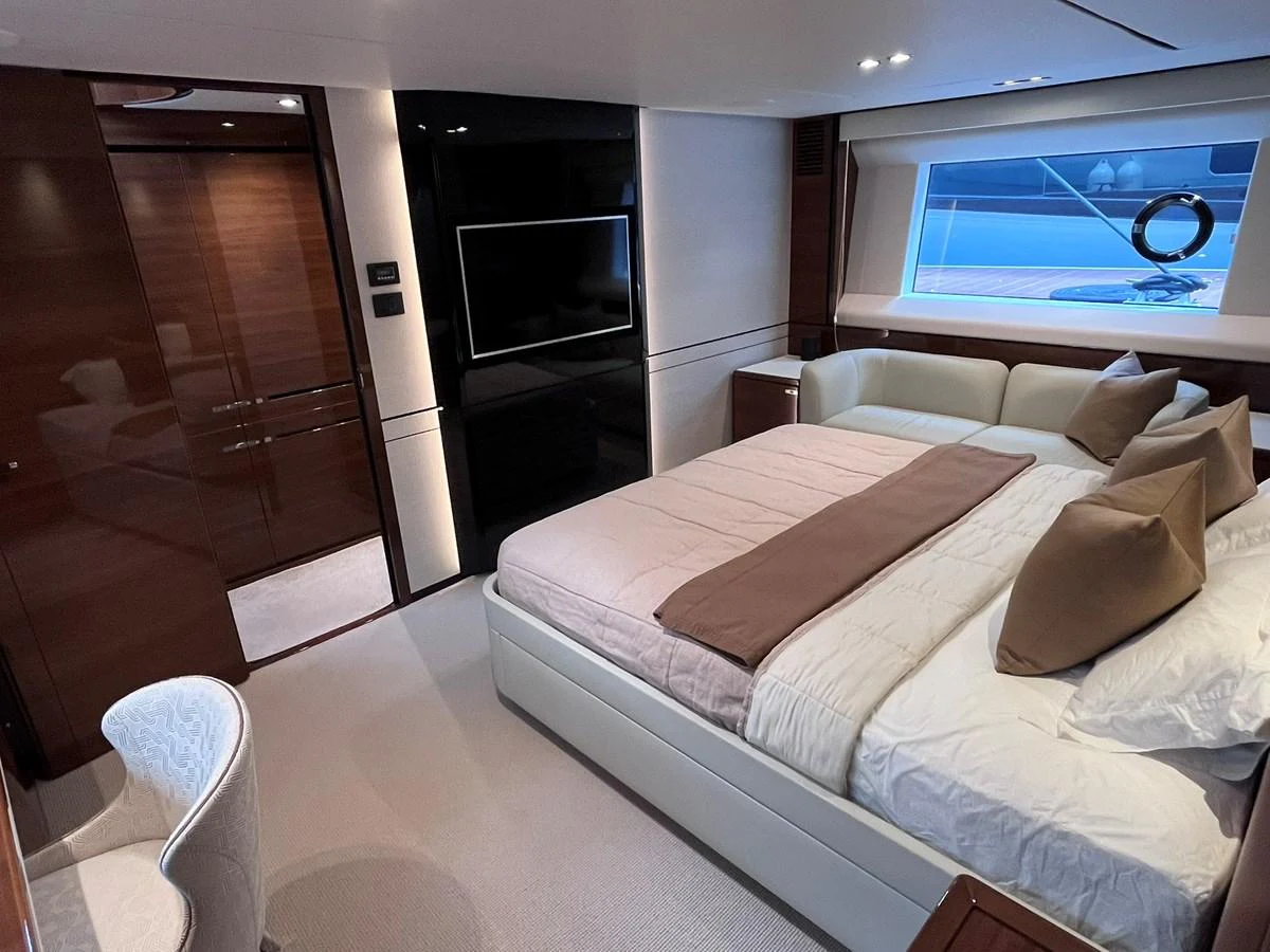 A luxurious stateroom featuring a plush bed, elegant furnishings, and a large window for natural light. aboard PRINCESS CHLOE Yacht for Sale