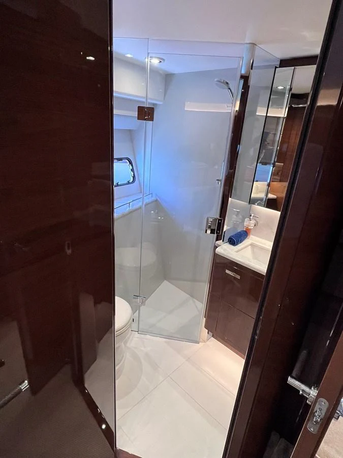 The yacht's bathroom features a sleek design with a glass-enclosed shower and modern fixtures. aboard PRINCESS CHLOE Yacht for Sale