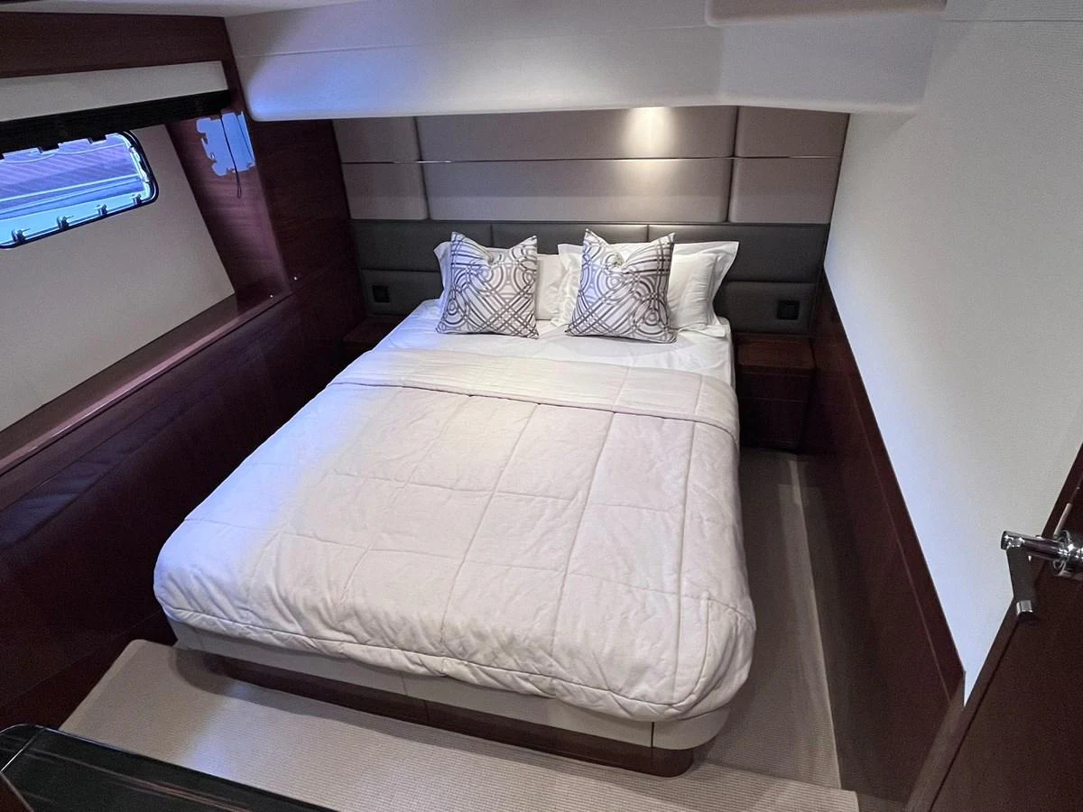 The stateroom features a comfortable double bed with elegant bedding and stylish pillows. aboard PRINCESS CHLOE Yacht for Sale