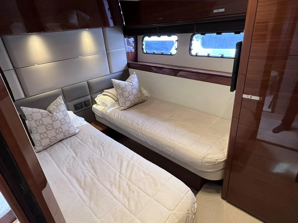 The twin stateroom offers cozy and comfortable sleeping arrangements with elegant bedding and ample natural light. aboard PRINCESS CHLOE Yacht for Sale