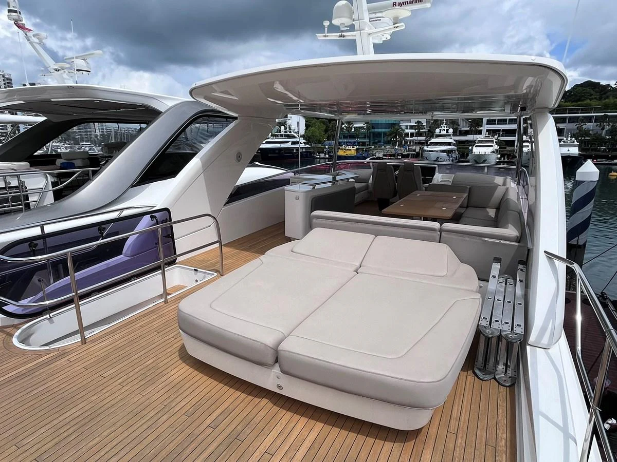 The flybridge features a spacious sunbathing area with plush loungers and a shaded dining space. aboard PRINCESS CHLOE Yacht for Sale